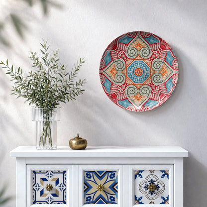 Decorative ceramic wall plate featuring symmetrical floral motifs, scrolls and geometric shapes
