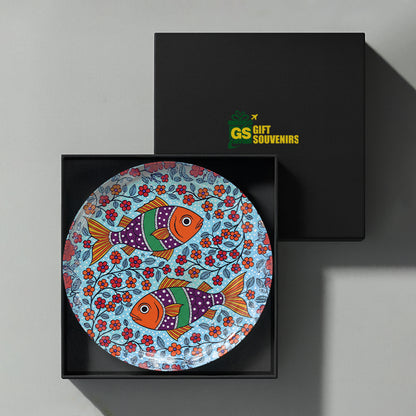 Indian folk art ceramic wall plate with colorful fish and floral artwork in a premium gift box
