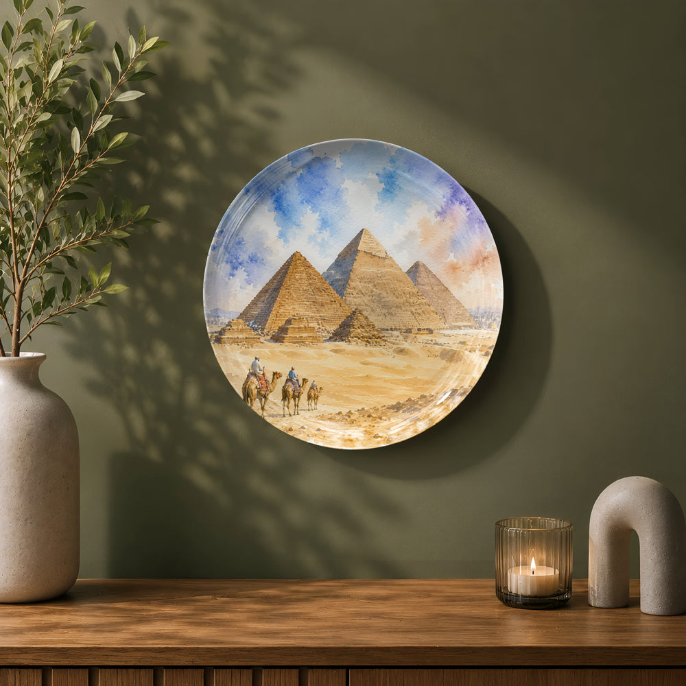 Egypt-inspired ceramic wall plate with the Great Pyramids and a desert camel caravan.