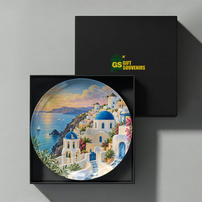 Santorini Greece ceramic wall plate featuring whitewashed homes, blue domes, sea views and sunset colours