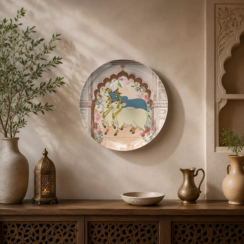 Premium ceramic wall plate inspired by Pichwai art depicting Lord Krishna and sacred cows beneath a Rajasthani floral arch.