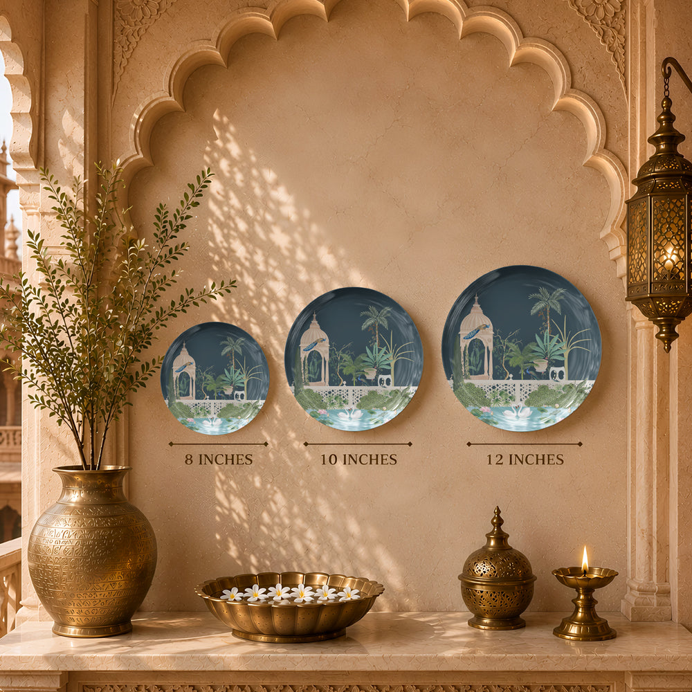 Decorative ceramic wall plate featuring a royal pavilion, lotus pond and botanical landscape inspired by Indian heritage.