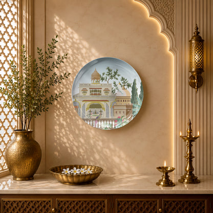 Indian Heritage Series ceramic wall plate showcasing a royal haveli courtyard with peacocks and lush greenery.