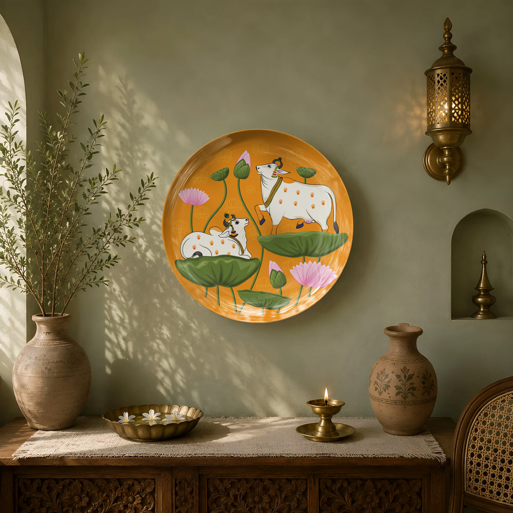 Museum-quality ceramic wall plate celebrating Indian heritage through Pichwai-inspired sacred cows and lotus blossoms.