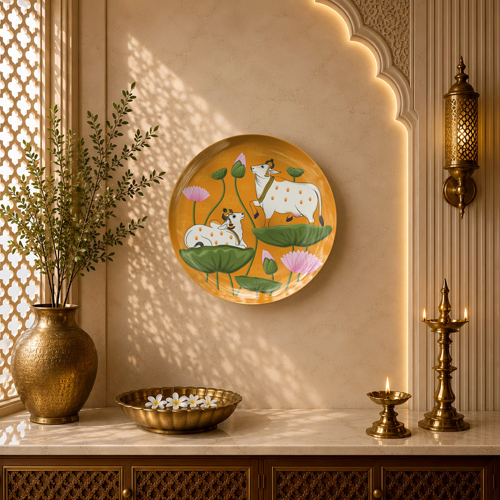 Indian Heritage Series ceramic wall plate showcasing sacred cows surrounded by lotus leaves on a saffron background.