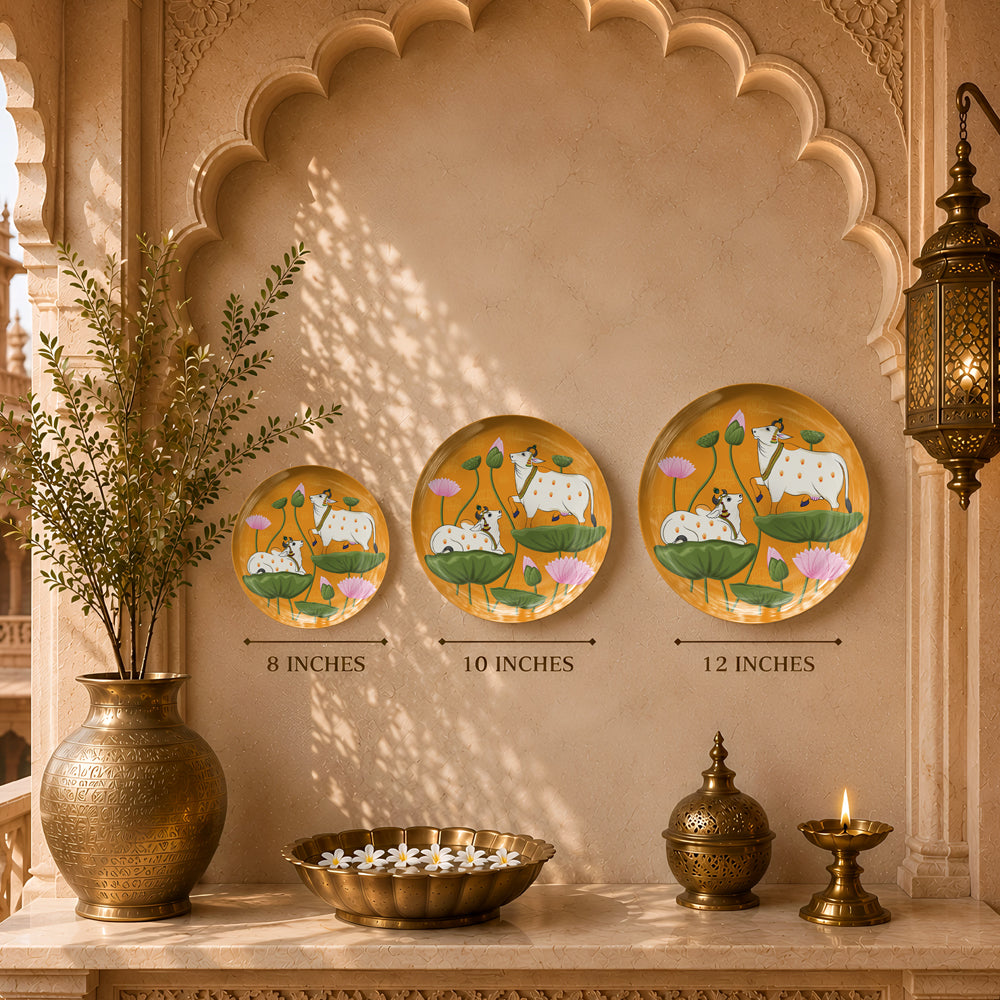 Decorative ceramic wall plate featuring traditional Indian sacred cow artwork with lotus flowers and botanical motifs.
