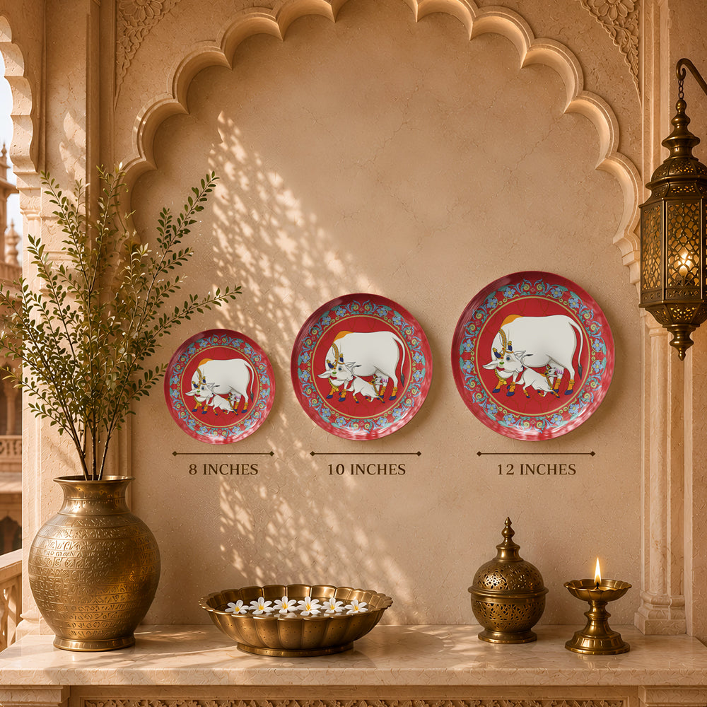 Decorative ceramic wall plate inspired by Pichwai paintings with sacred cow, calf and floral motifs.