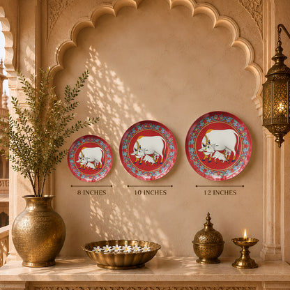 Decorative ceramic wall plate inspired by Pichwai paintings with sacred cow, calf and floral motifs.