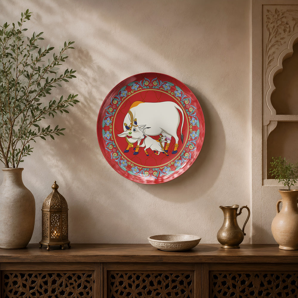 Premium ceramic wall plate showcasing Gau Mata and calf with an ornate floral border on a crimson background.