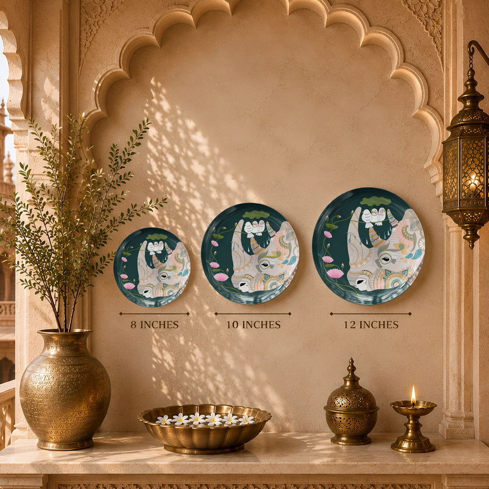 Decorative ceramic wall plate inspired by Pichwai art with sacred cow, lotus blossoms and botanical motifs.