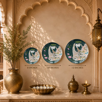 Decorative ceramic wall plate inspired by Pichwai art with sacred cow, lotus blossoms and botanical motifs.