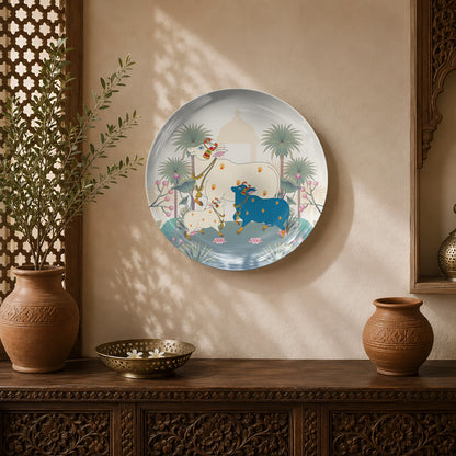 Lotus Blessings ceramic wall plate featuring sacred cows surrounded by lotus flowers in a Pichwai-inspired landscape.