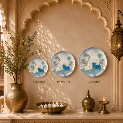 Decorative ceramic wall plate featuring a family of sacred cows in a peaceful lotus garden inspired by Indian art.