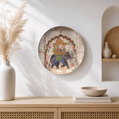 Ready-to-display ceramic wall plate featuring a decorated elephant carrying royal figures through a palace.