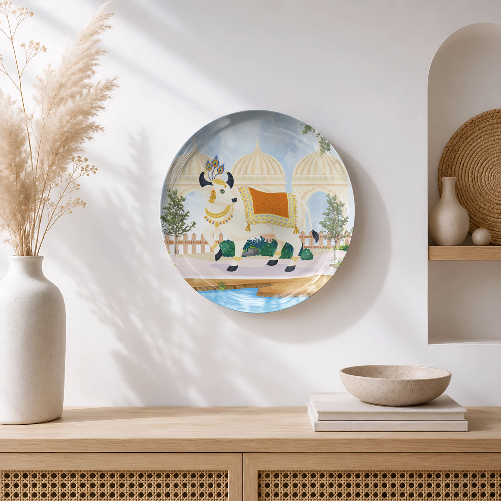Ready-to-display ceramic wall plate inspired by Pichwai paintings featuring a decorated sacred cow.