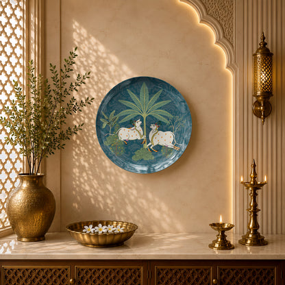 Indian Heritage Series ceramic wall plate showcasing two adorned sacred cows in a serene landscape.
