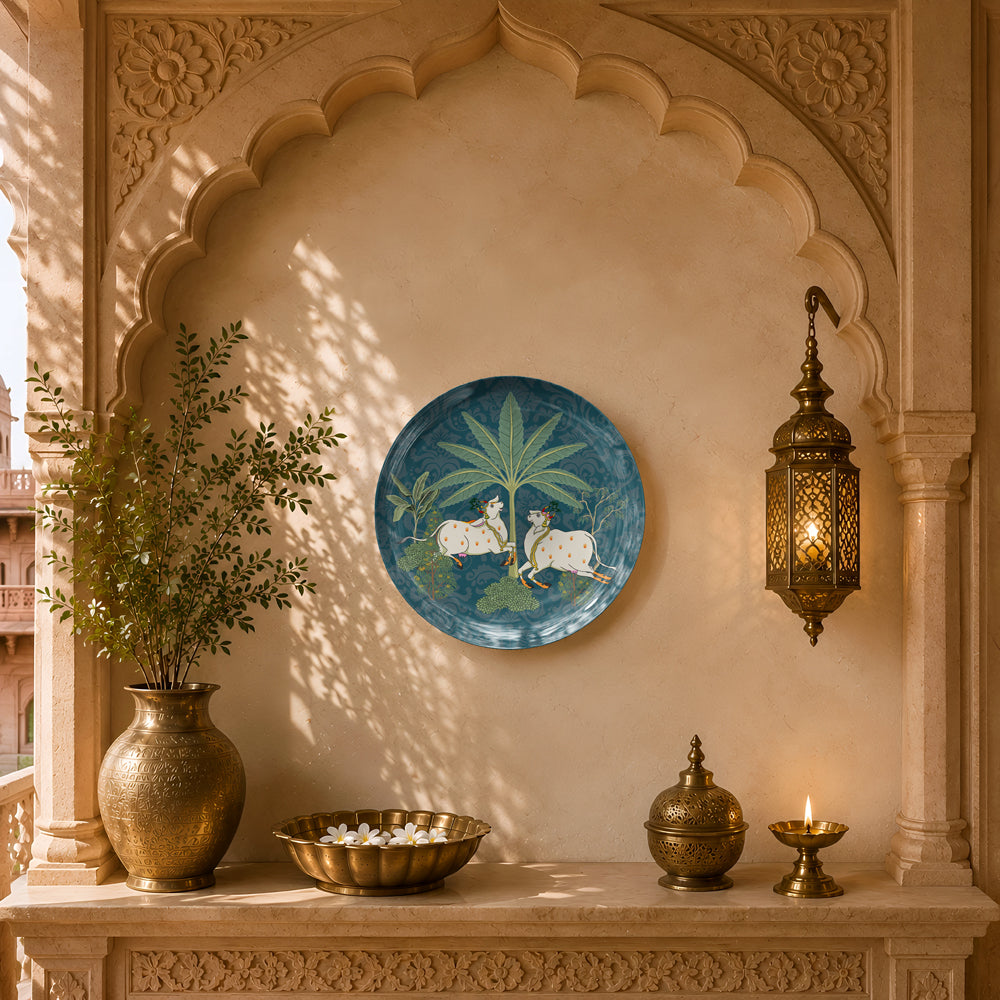 Luxury ceramic wall plate featuring sacred cows beneath tropical foliage in traditional Indian artwork.