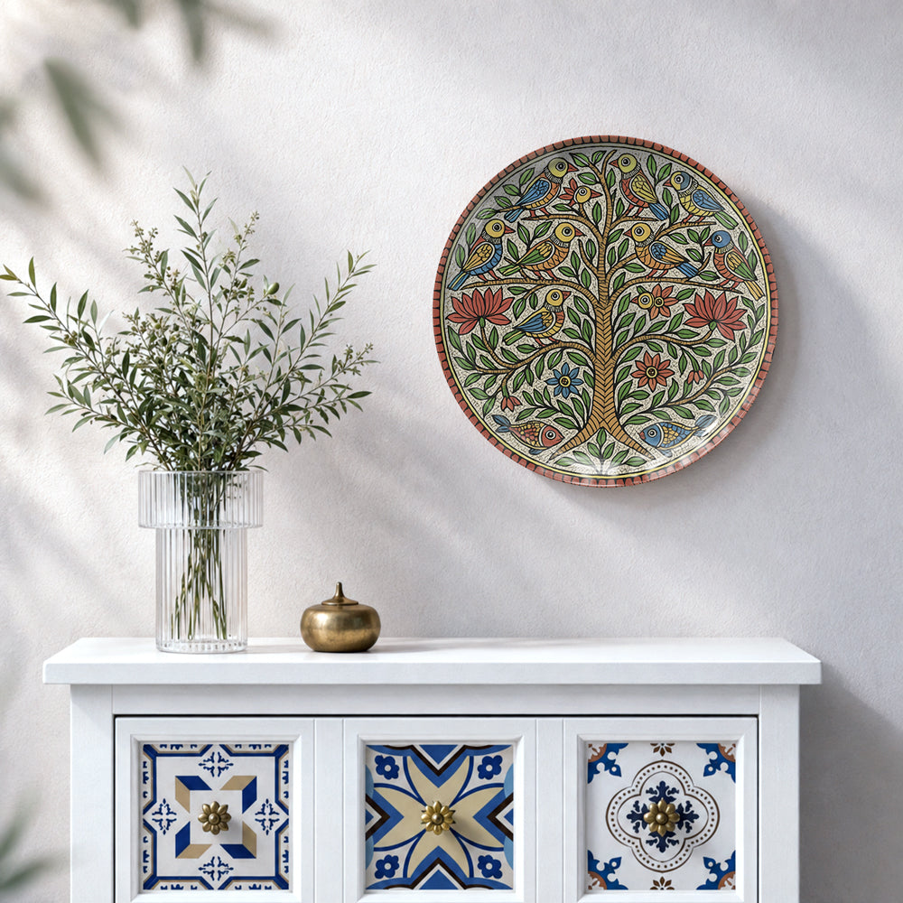 Traditional Indian folk art ceramic wall plate featuring a colourful Tree of Life inspired by Madhubani painting.
