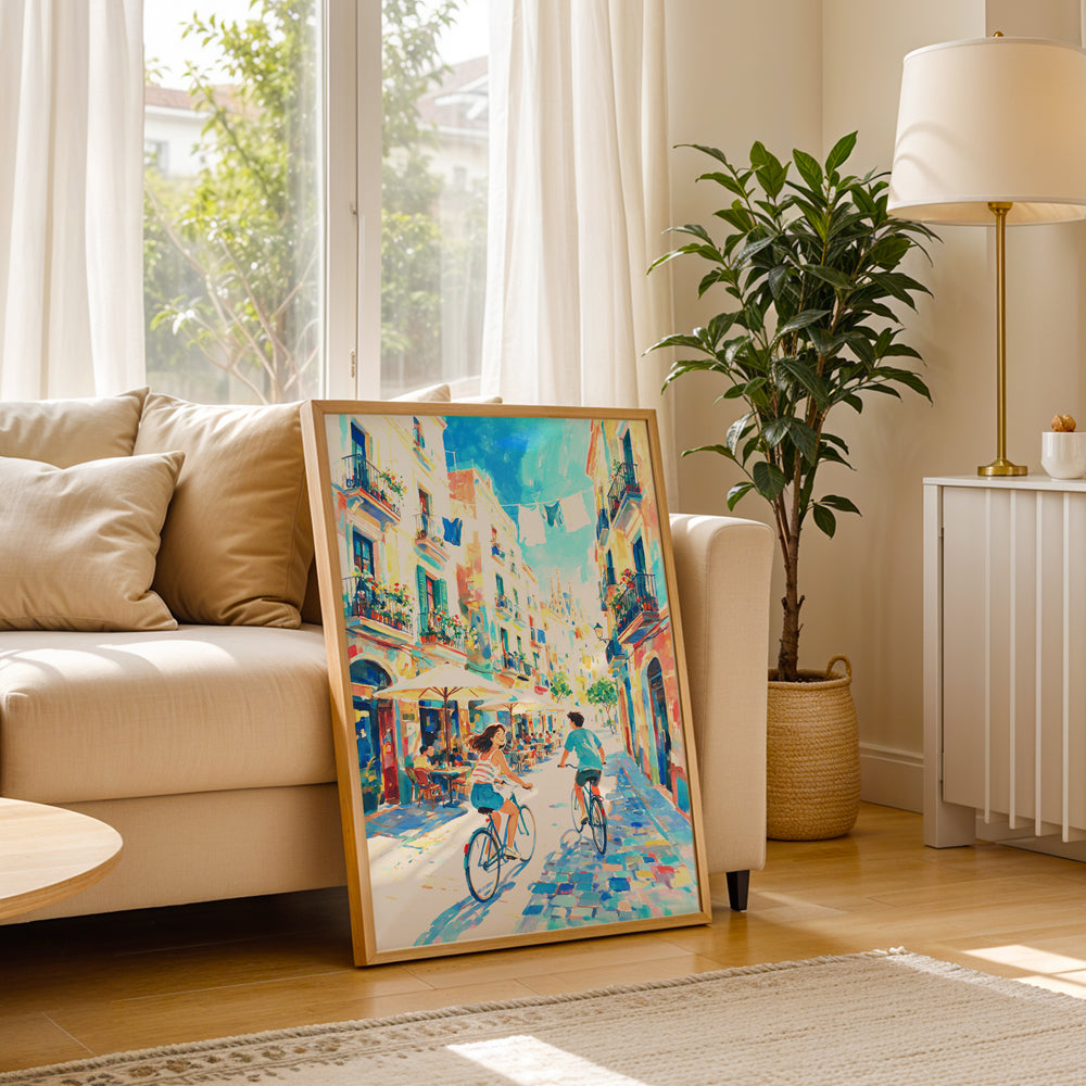 Sunlit Barcelona street artwork with two cyclists, colourful buildings, flower-filled balconies, and outdoor cafés